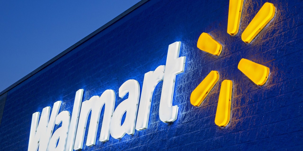 The header image shows a photograph of a lit up Walmart sign.