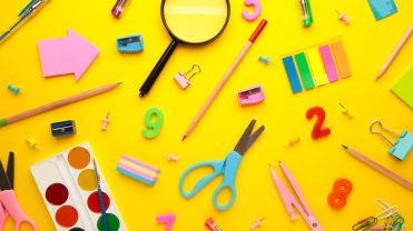 School supplies on yellow background. Back to school concept.
