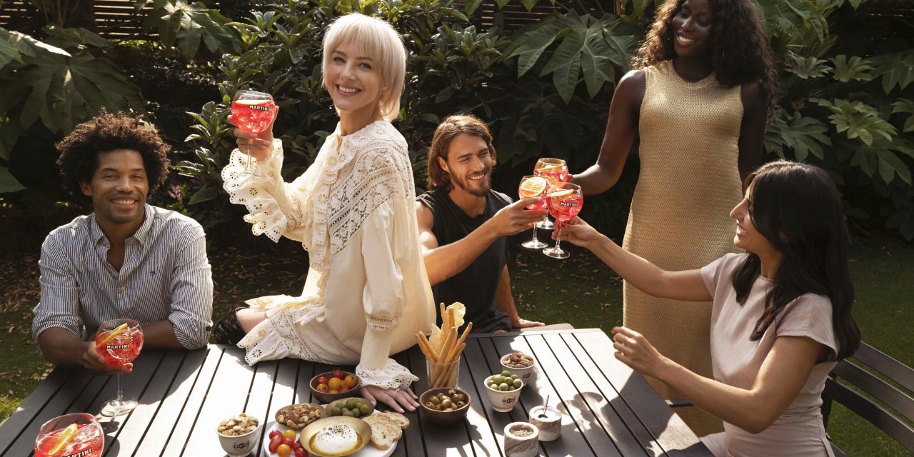 The lead image shows a group of people drinking together.