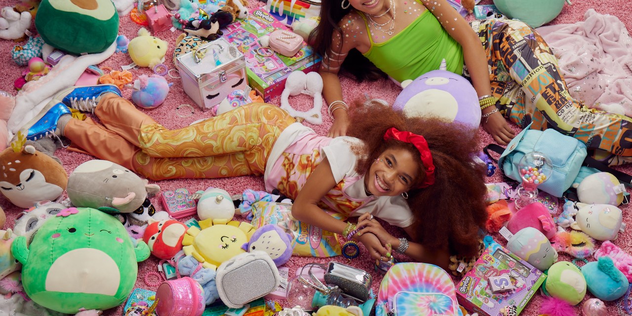 Photograph of two young girls surrounded by various products from Claire's.