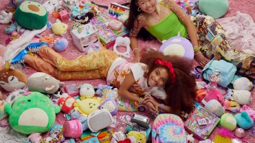 Photograph of two young girls surrounded by various products from Claire's.