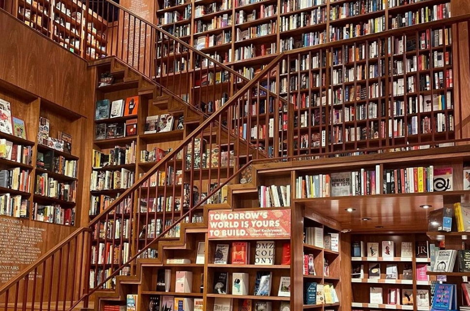 Photograph inside a large two story bookstore filled from floor to ceiling with books.