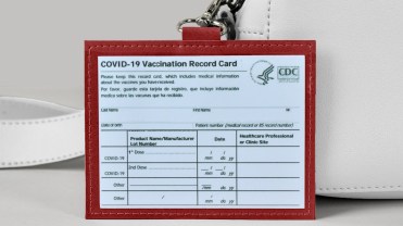 The lead image shows a vaccine card holder.