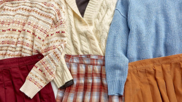 Red, white, and blue sweaters laid out with red, plaid and orange skirts