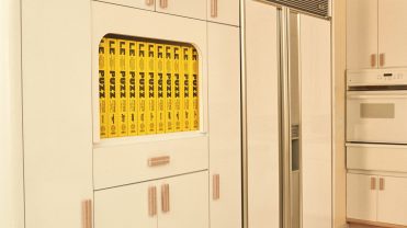 Yellow puzzles hidden in a wall of white kitchen appliances