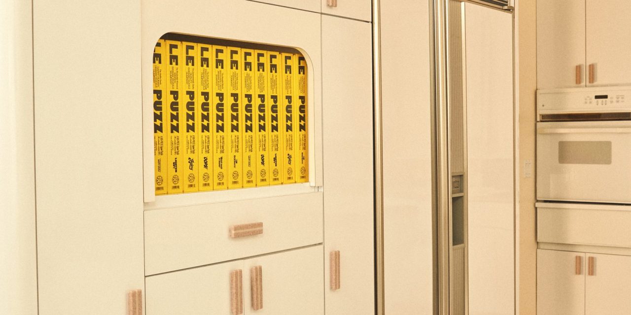 Yellow puzzles hidden in a wall of white kitchen appliances