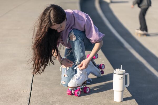 Roller skater poses next to Stanley product