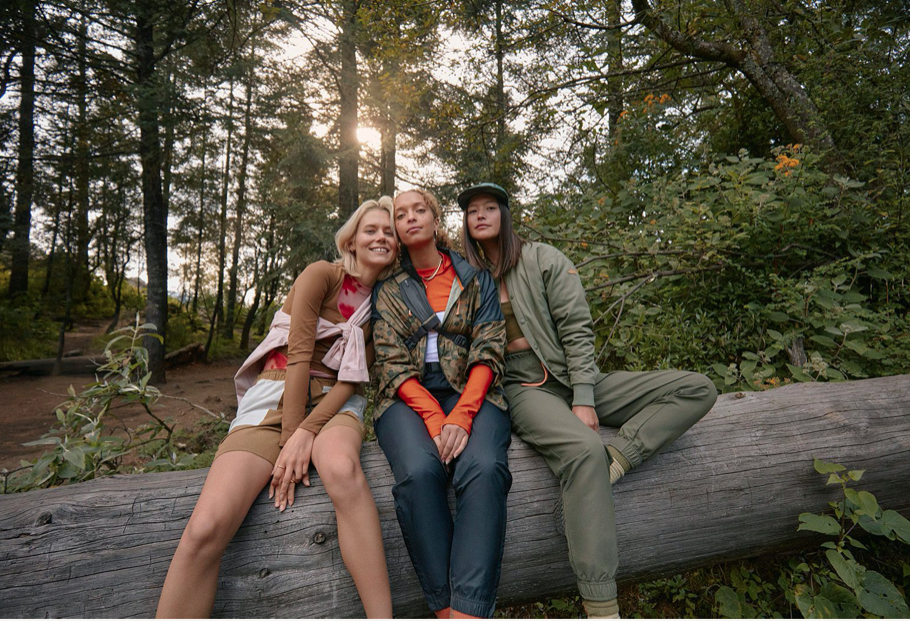 Women sitting on log in Merrell gear