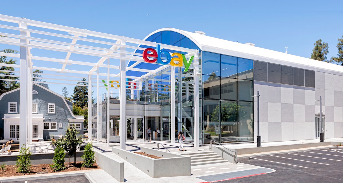 A glass building glistens in the sun at eBay's San Jose, California headquarters