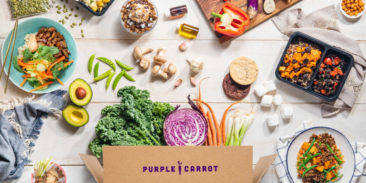 Meal kit box from purple carrot with vegetables like green cale, purple cabbage and orange carrots