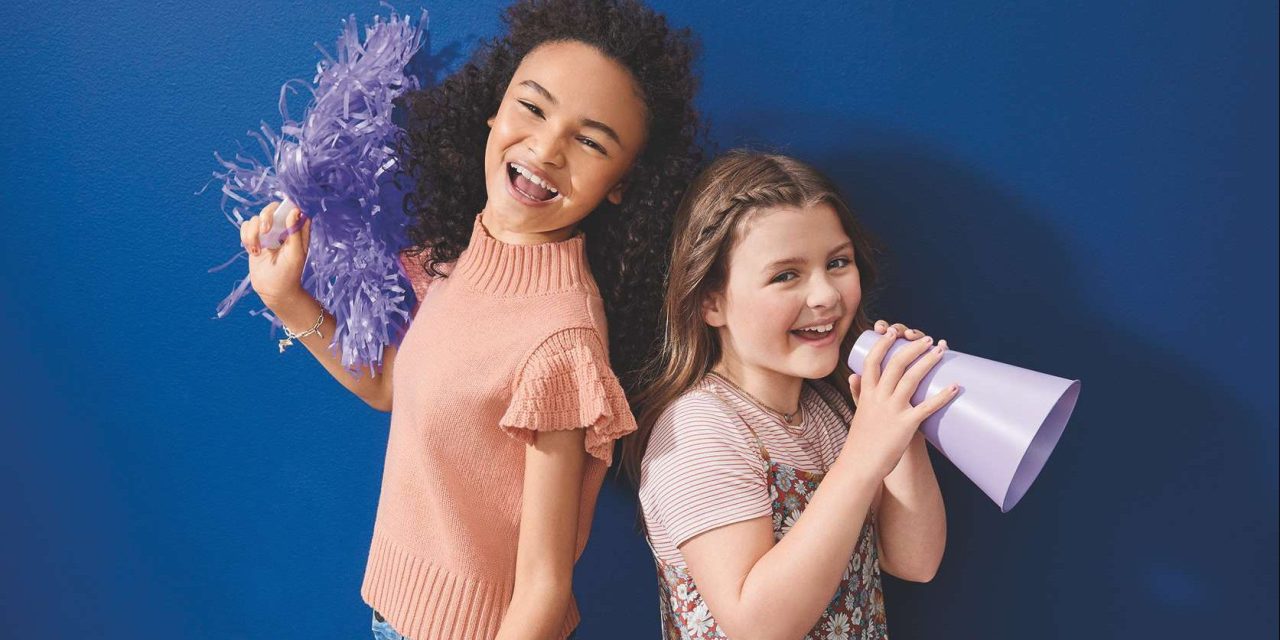 Two young girls dressed in Evsie products