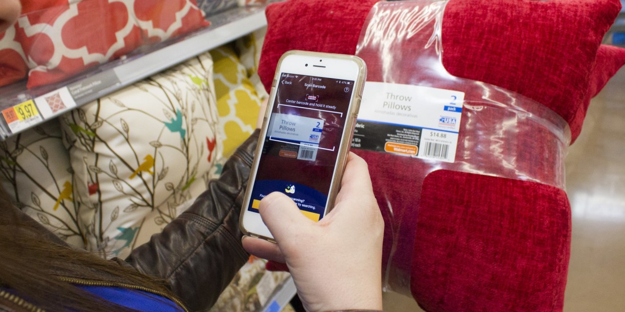 A woman uses her phone to scan her purchases