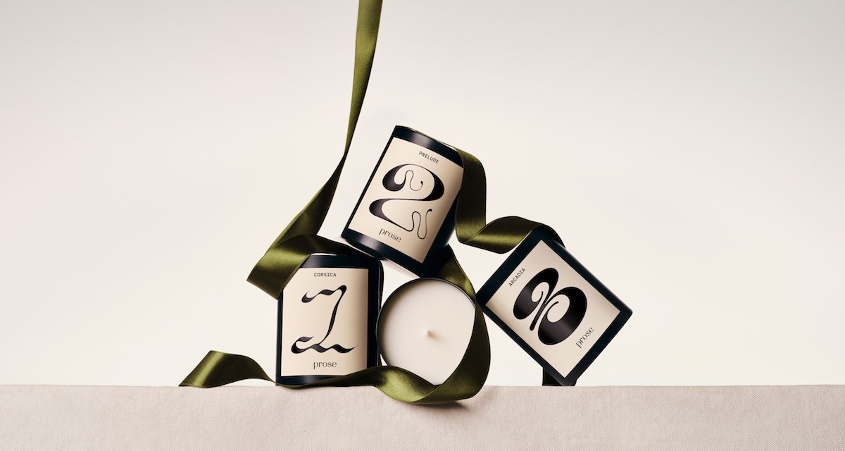 Prose candles with white labels and black text, adorned with green ribbons