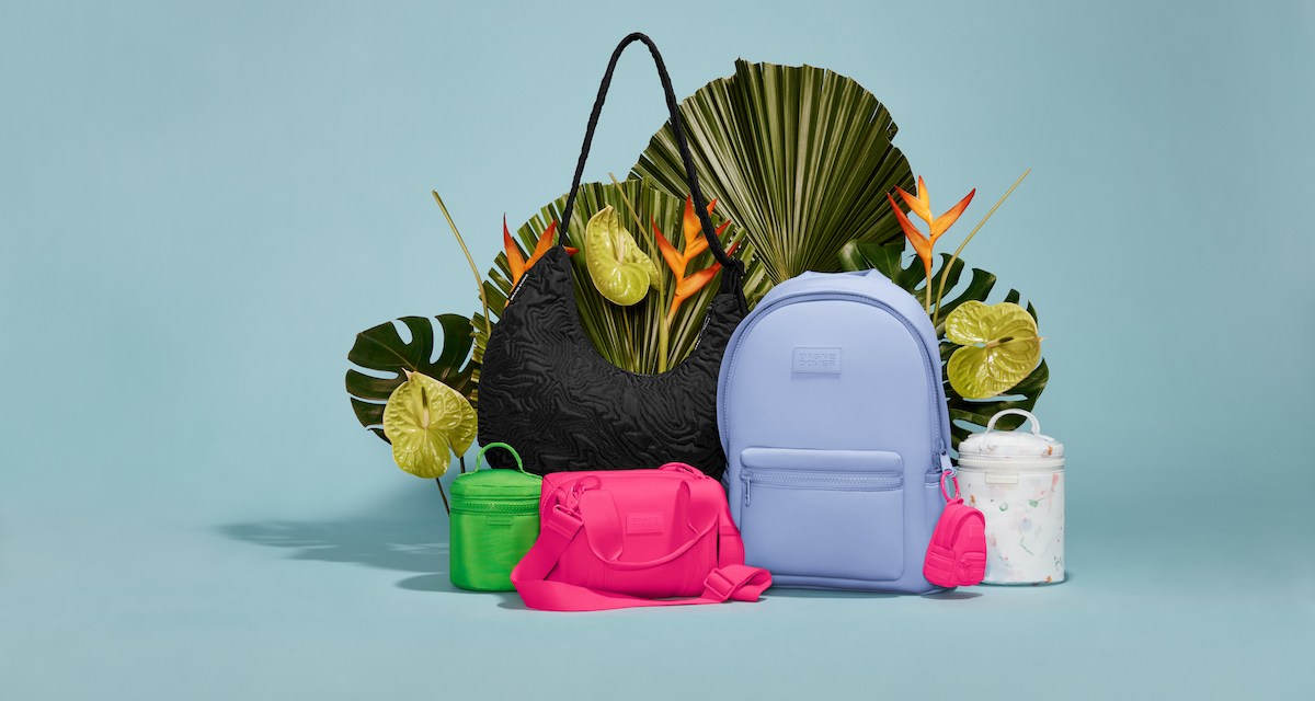 Assortment of hot pink, lime green and bright blue handbags and backpacks on a blue background, surrounded by leaves