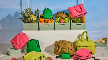 Calpak's duffel bags and backpacks in pink, green and brown colorways.