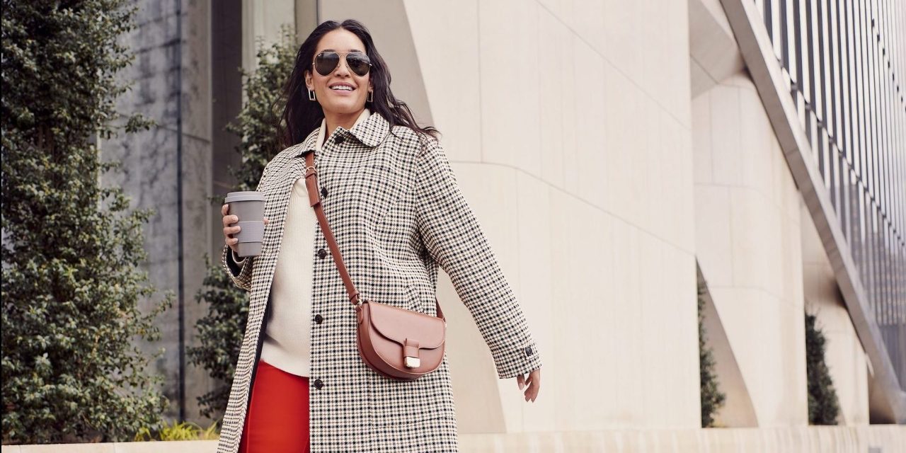 Woman wearing Macy's private label clothes walks down the street